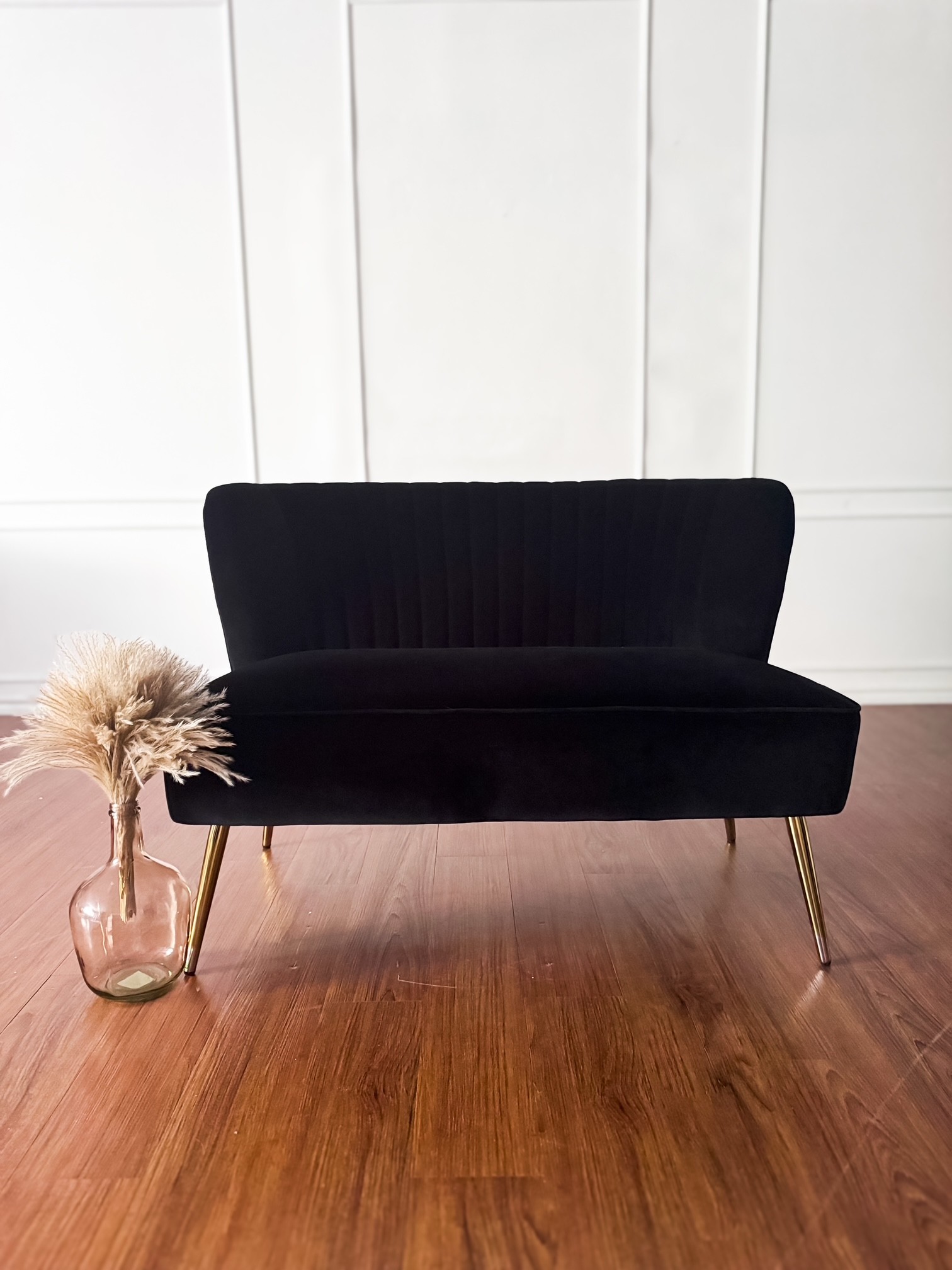 Seating against the bright paneled wall in the large studio room