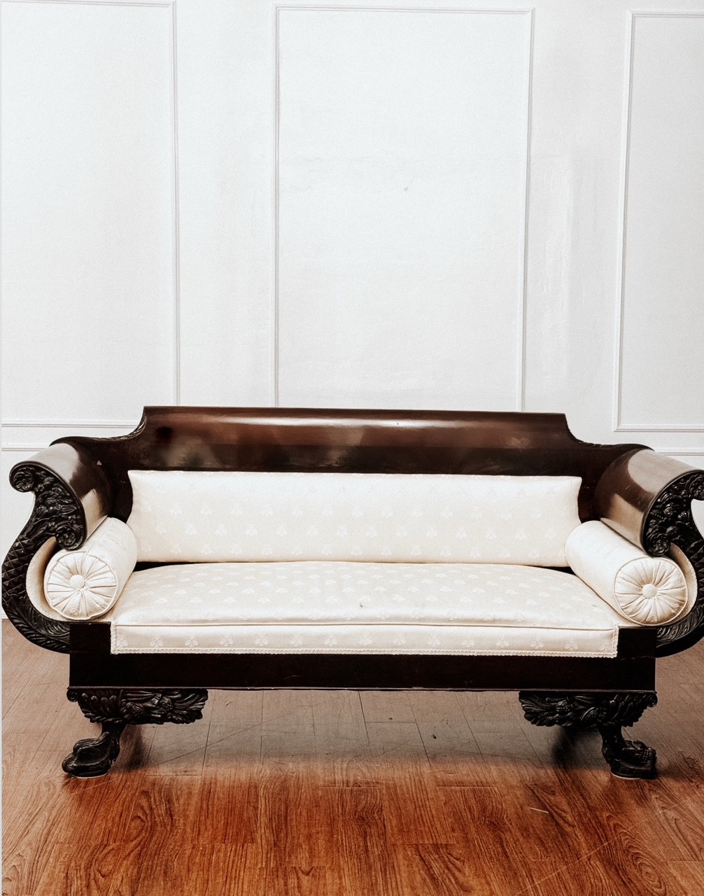Vintage sofa against a white paneled wall