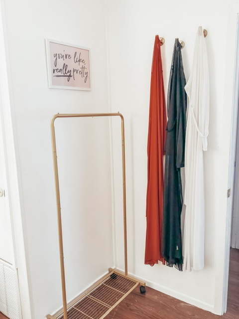Garment rack and mirror in the glam room