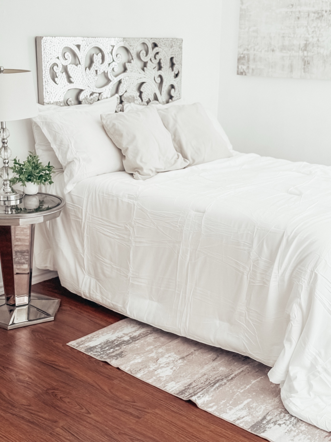 Bright studio bedroom setup with white bedding