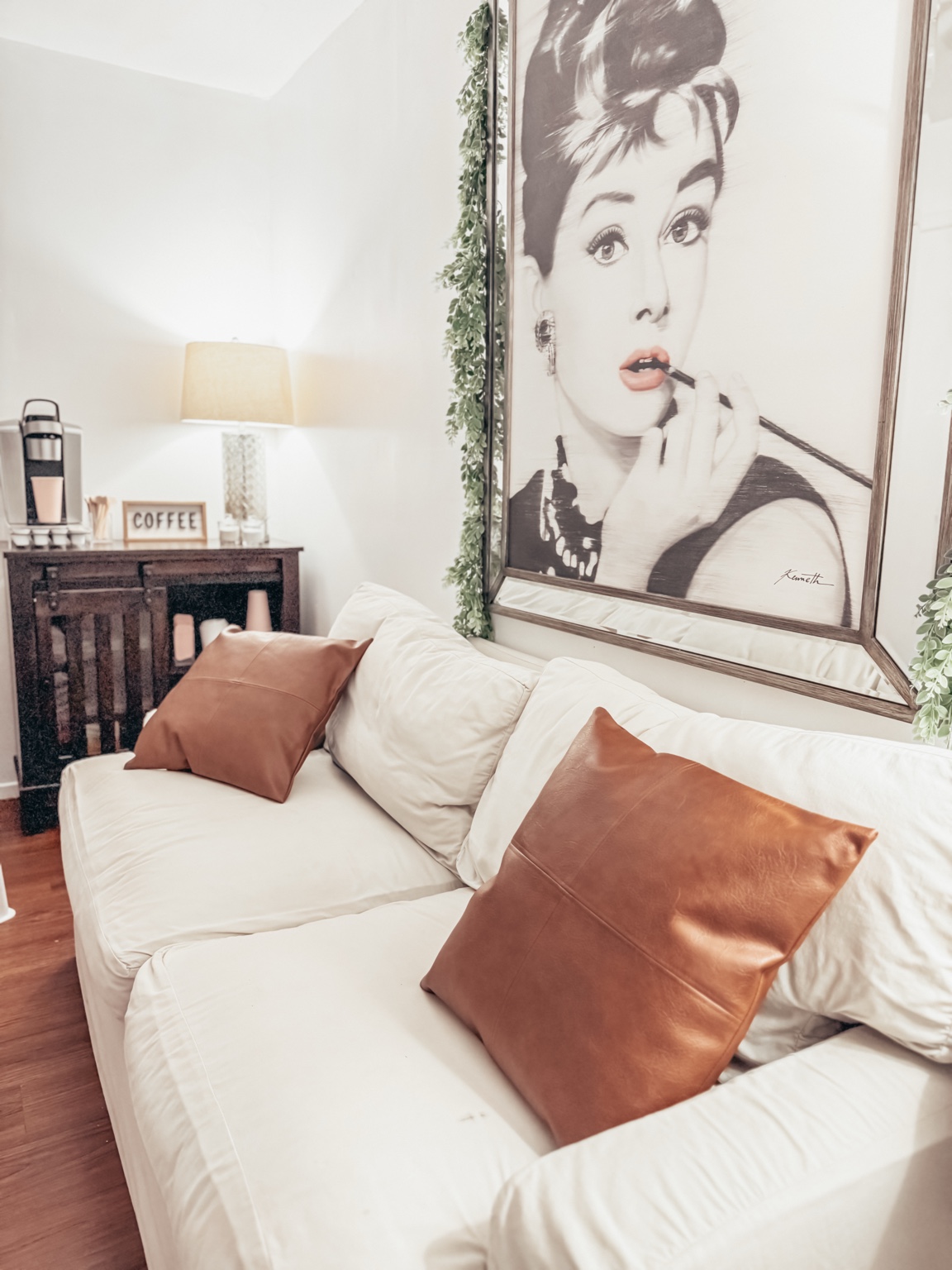 Glam room sofa and portrait artwork