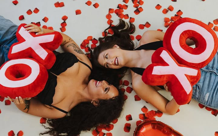 Valentine portrait with XOXO props and rose petals